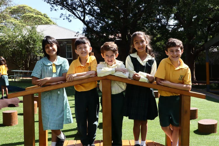 Photograph of five students standing on a play bridge.
