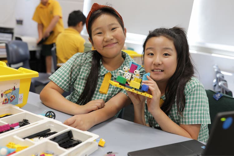 Photograph of two students who have completed their Lego STEM project.
