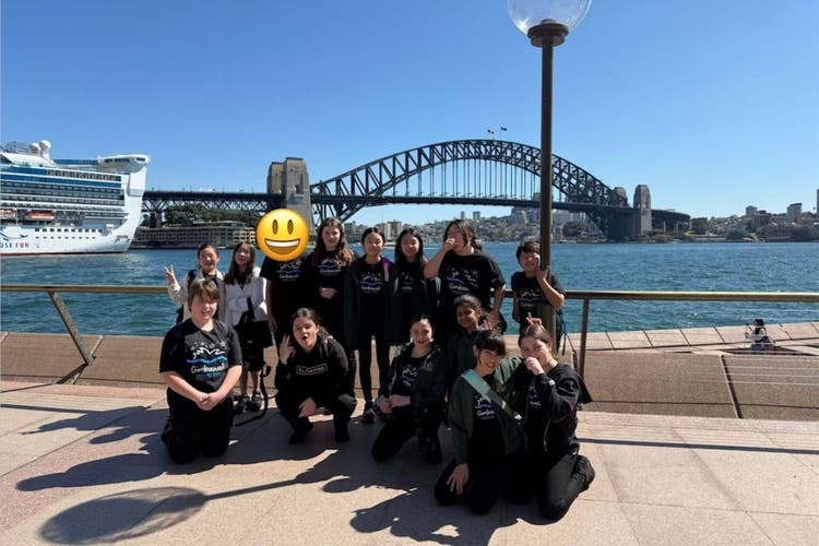 Photograph of the school choir in front of the Sydney Harbour Bridge.