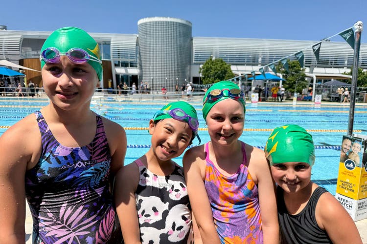 Photograph of four female students at the zone swimming carnival.