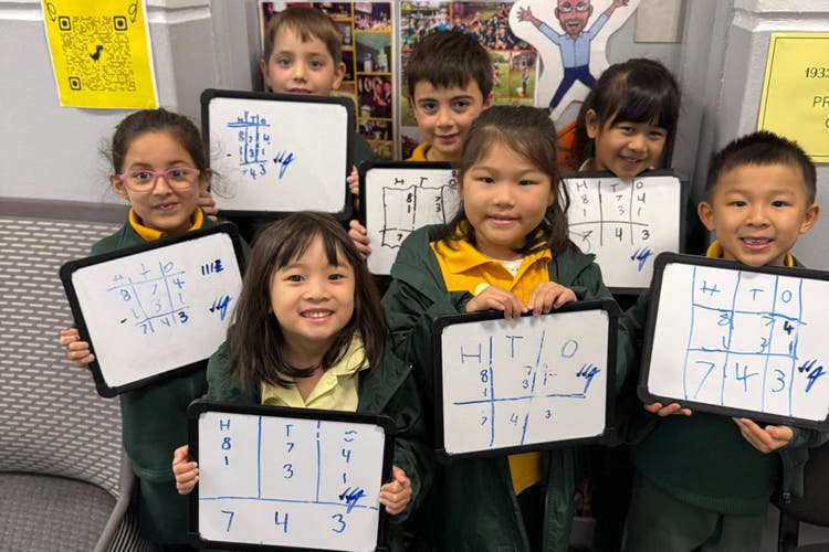 Photograph of year 1 students showcasing their mathematics work on place value.