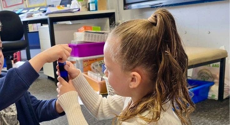 Photograph of kindergarten student playing with blocks.